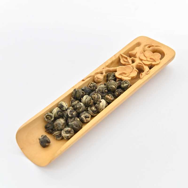 Jasmine Pearl Green Tea in a scoop